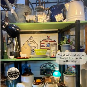 Decorating with Vintage on a Budget - collection of an old watering can, butter churn, enamel coffee pot, crocks, whiskey jub